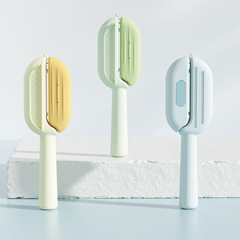 Three cleaning brushes with different color handles on a light background